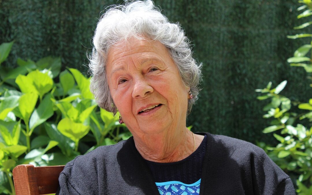 older lady sitting in garden waiting for cup of tea